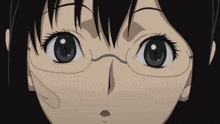 a close up of a girl wearing glasses looking at the camera