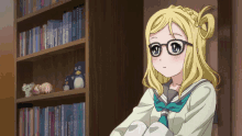a girl with blonde hair and glasses is sitting in front of a bookshelf