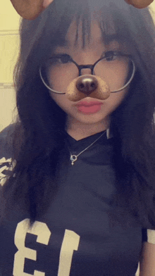 a girl wearing glasses and a dog mask with the number 3 on her shirt