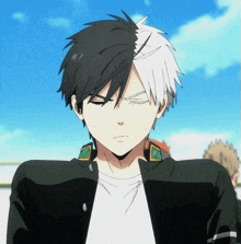 a man with half black and half white hair is making a face