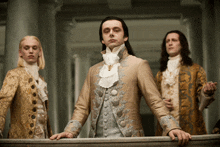 a man in a fancy costume is standing next to two other men