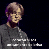 a man wearing glasses and a black shirt says " corazon si sos unicamente de brisa "