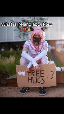 a person holding a sign that says free hugs on it