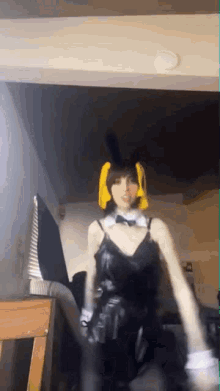 a woman is wearing a bunny costume and dancing in a room .
