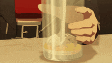 a person is holding a glass with ice in it and the letter c is visible