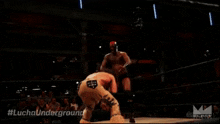 a wrestler in a wrestling ring with #luchaunderground written on the bottom