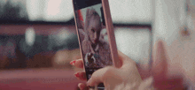a woman is taking a selfie with her cell phone