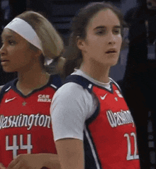 two women wearing washington uniforms number 44 and 22