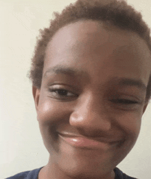 a close up of a person 's face with a slight smile