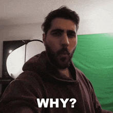 a man with a beard is taking a selfie with the words why behind him