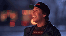 a man wearing a hat with the word dhl on it is laughing