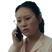 a woman wearing glasses is talking on her cell phone