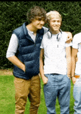 a man wearing headphones is hugging another man
