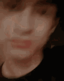 a close up of a person 's face with a dark background