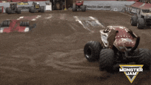 a monster jam logo can be seen on the side of a dirt track