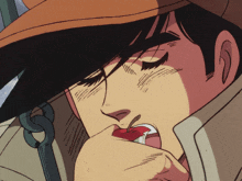 a man in a hat is eating an apple with his eyes closed