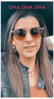 a woman wearing sunglasses and a leather jacket has the name gna gna gna on the bottom