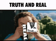 a man is holding a sticker that says truth and real