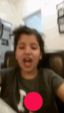 a little girl wearing a gray shirt with the letter i on it