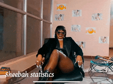a woman is sitting in a chair with the words sheebah statistics behind her