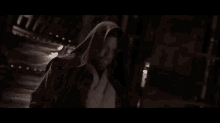a man with a beard is standing in front of a sign that says `` hello there '' .