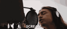 a woman is singing into a microphone and the word scream is on the bottom