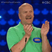 a man in a green shirt with the name david on the front