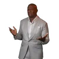 a man in a suit is making a funny face and the word what is behind him