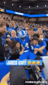 a football player named jared goff is being surrounded by fans