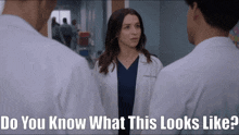 a woman in a lab coat stands between two men with the words do you know what this looks like below her
