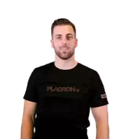 a man wearing a black t-shirt that says place is pointing at something