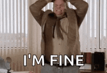 a man is standing in an office with his hands on his head and screaming .