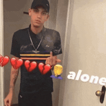 a man is standing in front of a door holding a broken heart and the word alone in the corner