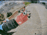 a person is holding a small drone in their hand in front of a graffiti wall