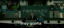 a man stands at a podium with a sign that says forward