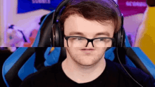 a man wearing glasses and headphones is making a face