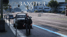 a police officer is walking down a street in front of a car that says " zaxotel " on it