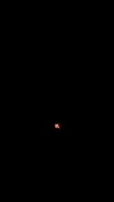 a red lightning bolt strikes in the dark