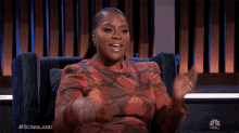 a woman sitting in a chair with her hands in the air and the words songland on the bottom right