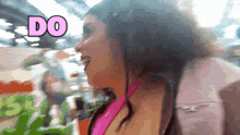 a woman in a pink shirt with the word do in pink