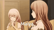 two anime girls are sitting next to each other and the word maiya is on the bottom