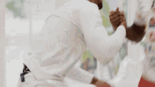 a blurry picture of two men fighting with dazn written on the bottom right