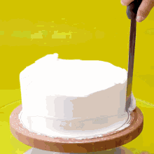 a person is using a knife to cut a hole in a glass circle