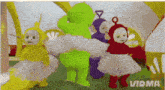 a group of teletubbies standing next to each other with vidma written on the bottom right