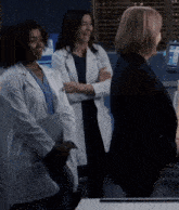 three female doctors standing next to each other with one wearing a name tag that says ' dr. '