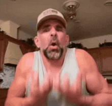 a man with a beard and a hat is making a funny face .