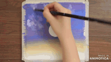 a person is painting with a brush and the words made in animatica are visible