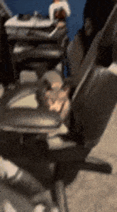 a person is sitting in a chair in front of a desk with a laptop .