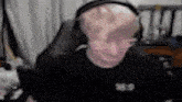 a man wearing headphones and glasses is sitting in a chair .