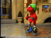 elmo wearing roller skates and a green helmet stands on a sidewalk